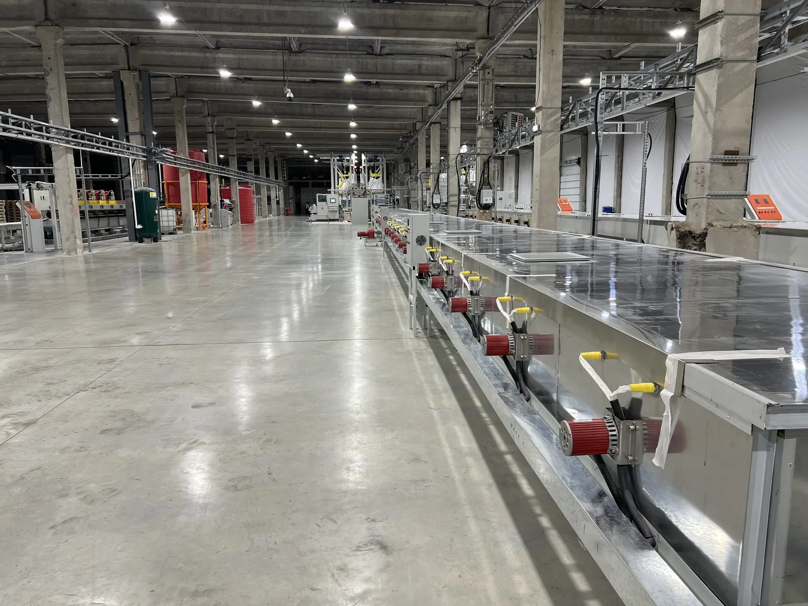 Main hall of the LISTACRYL plant in Kirishi — the casting line running the full length of the bay