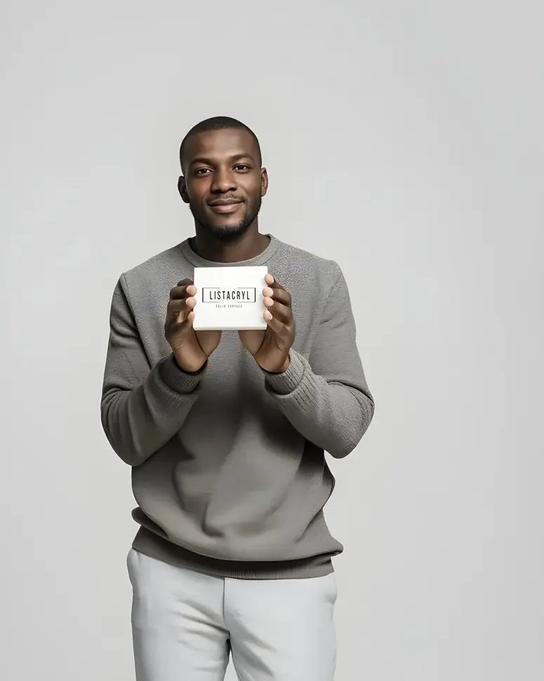 A LISTACRYL employee holding a white sample of acrylic solid surface sheet