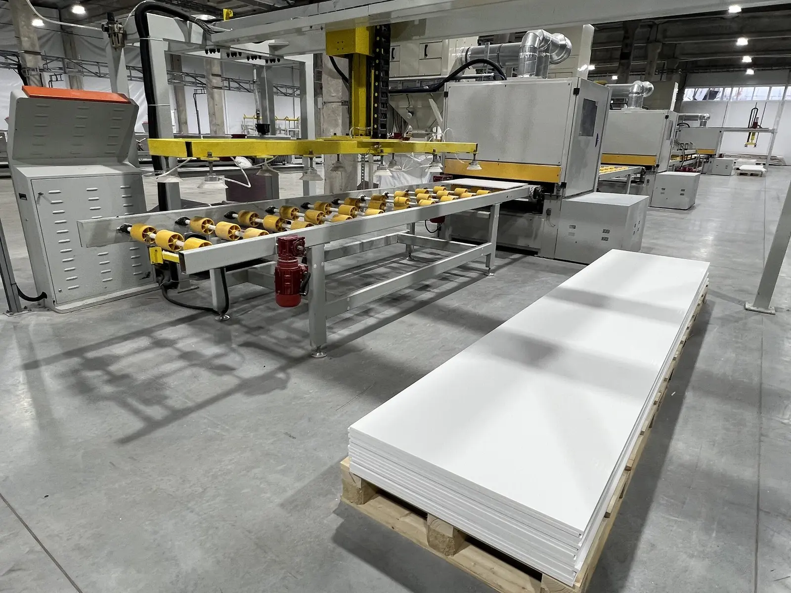 Vacuum gantry stacking a finished LISTACRYL acrylic solid surface sheet on a pallet
